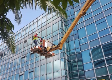 High-rise facade cleaning using a boom lift